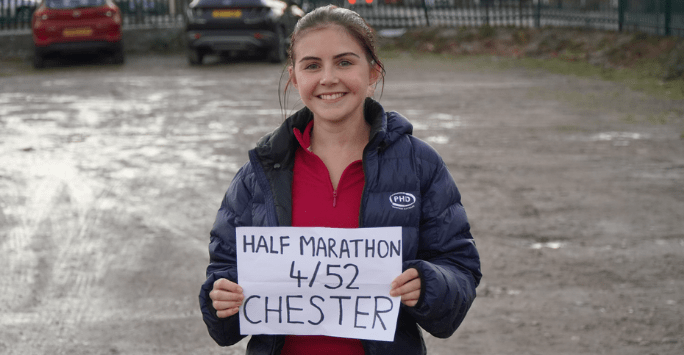 marathon runner holding sign