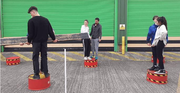 students move planks as part of a leadership activity