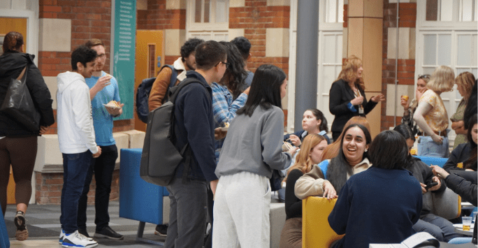 students mix and mingle in a communal hub area