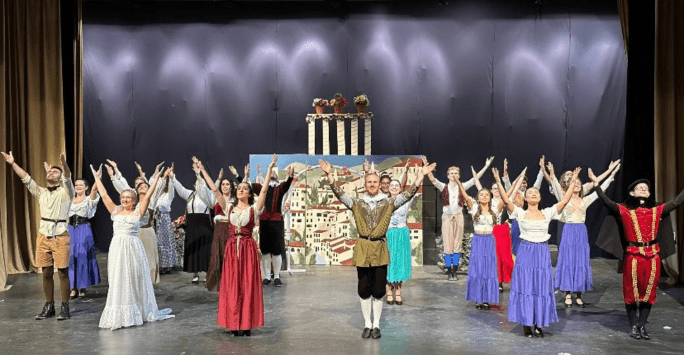 performers on stage in Shakespearian costume