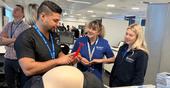 people interact with a mannequin at technical showcase