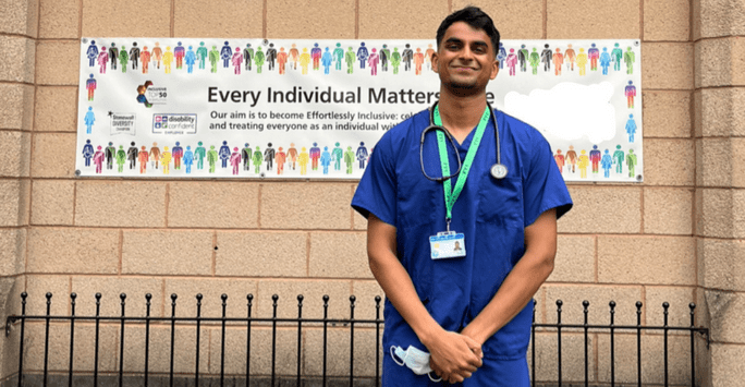 doctor in scrubs outside trust on first day