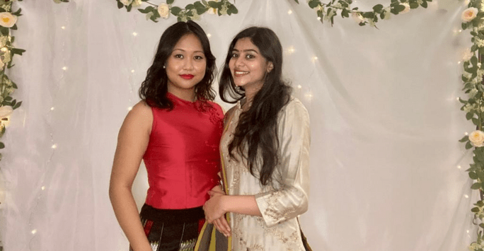 two women in traditional dress at culture ball