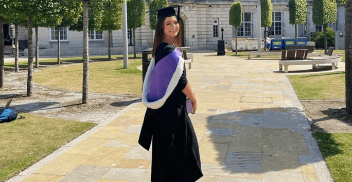 woman in graduation cap and gown