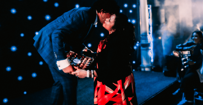 presenter kisses his mum as she presents him with a box of chocolates