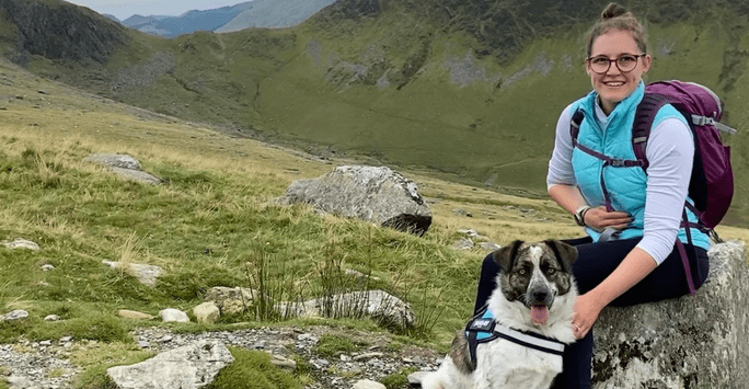 woman and dog in the mountains