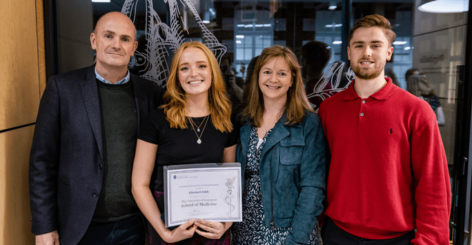 a prize winner poses with her family