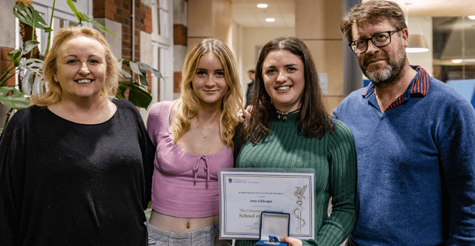 a prize winner poses with her family