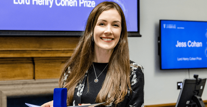 a student prize winner collects her medal and certificate