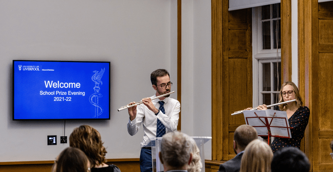 a man and woman play the flute