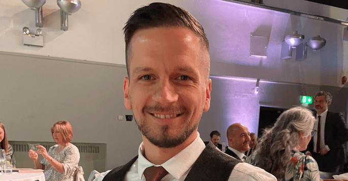 man wearing shirt, tie and waistcoat