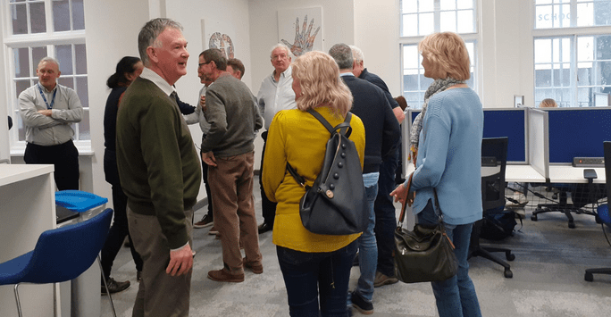 a group of people tour a study area