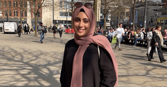 woman wearing a pink headscarf and sunglasses