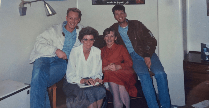 two students pose with two wardens during the 1980s