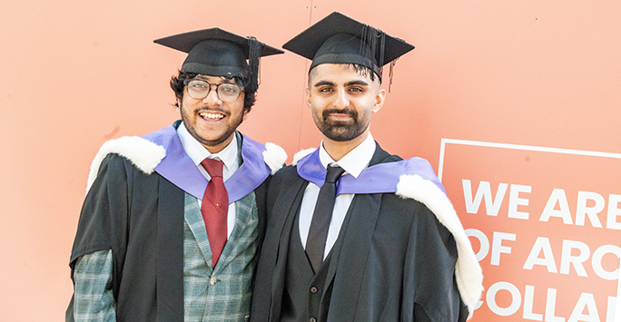 Two graduates smiling