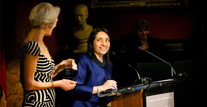 Dr Patel receives her award and speaks at the podium