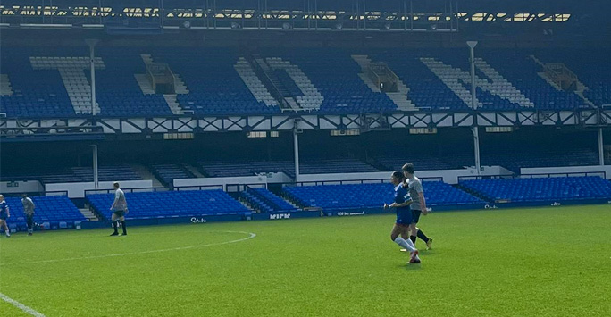 Team member kicking the ball during the football match