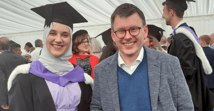 a graduate poses with her favourite lecturer