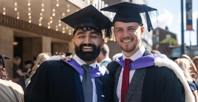 two graduates outside the philharmonic hall