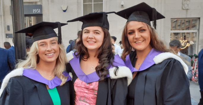 graduates outside the philharmonic hall