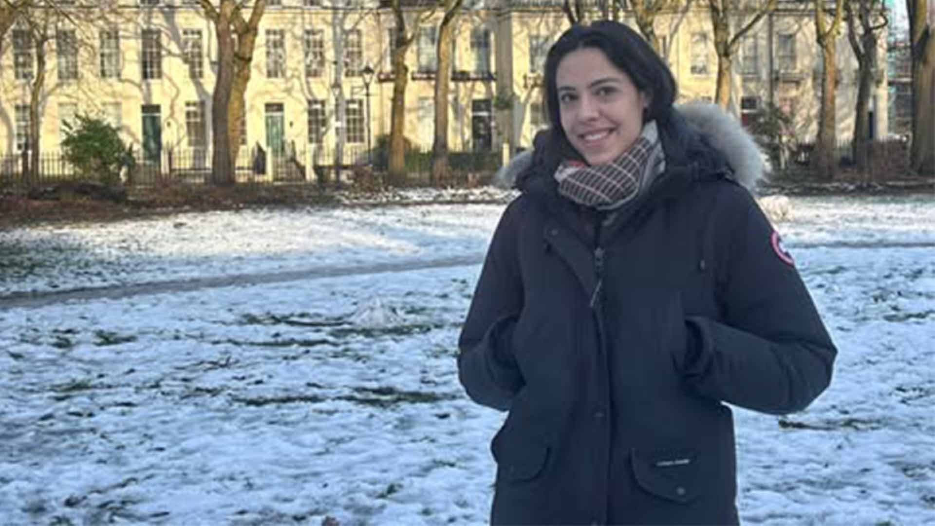 woman standing in snow covered park