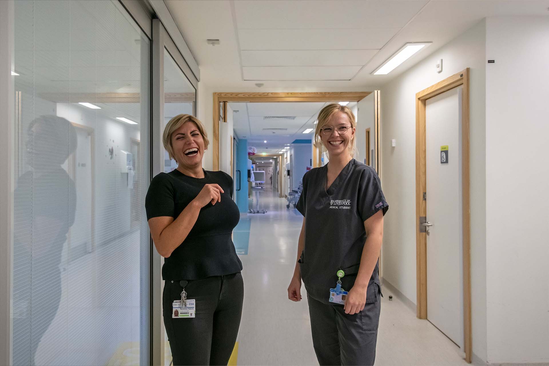 An image of two women interacting, one is an older clinical doctor, one is a younger student doctor.