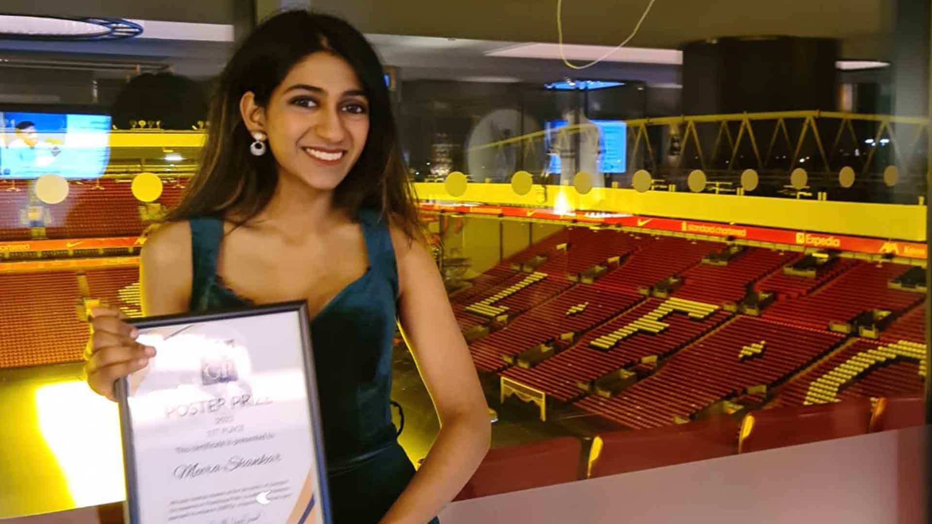 woman with prize certificate in stadium