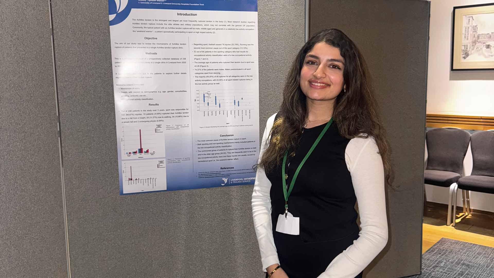 student in front of a research poster