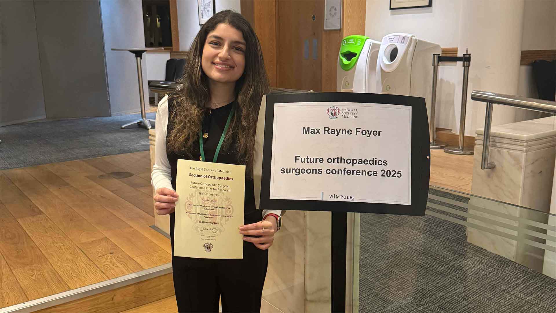 student with prize certificate at academic conference