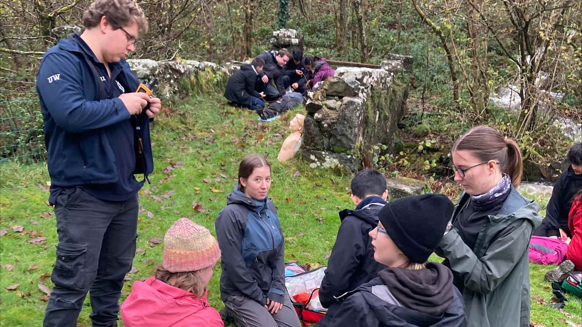 students participate in simulated medical scenarios outdoors