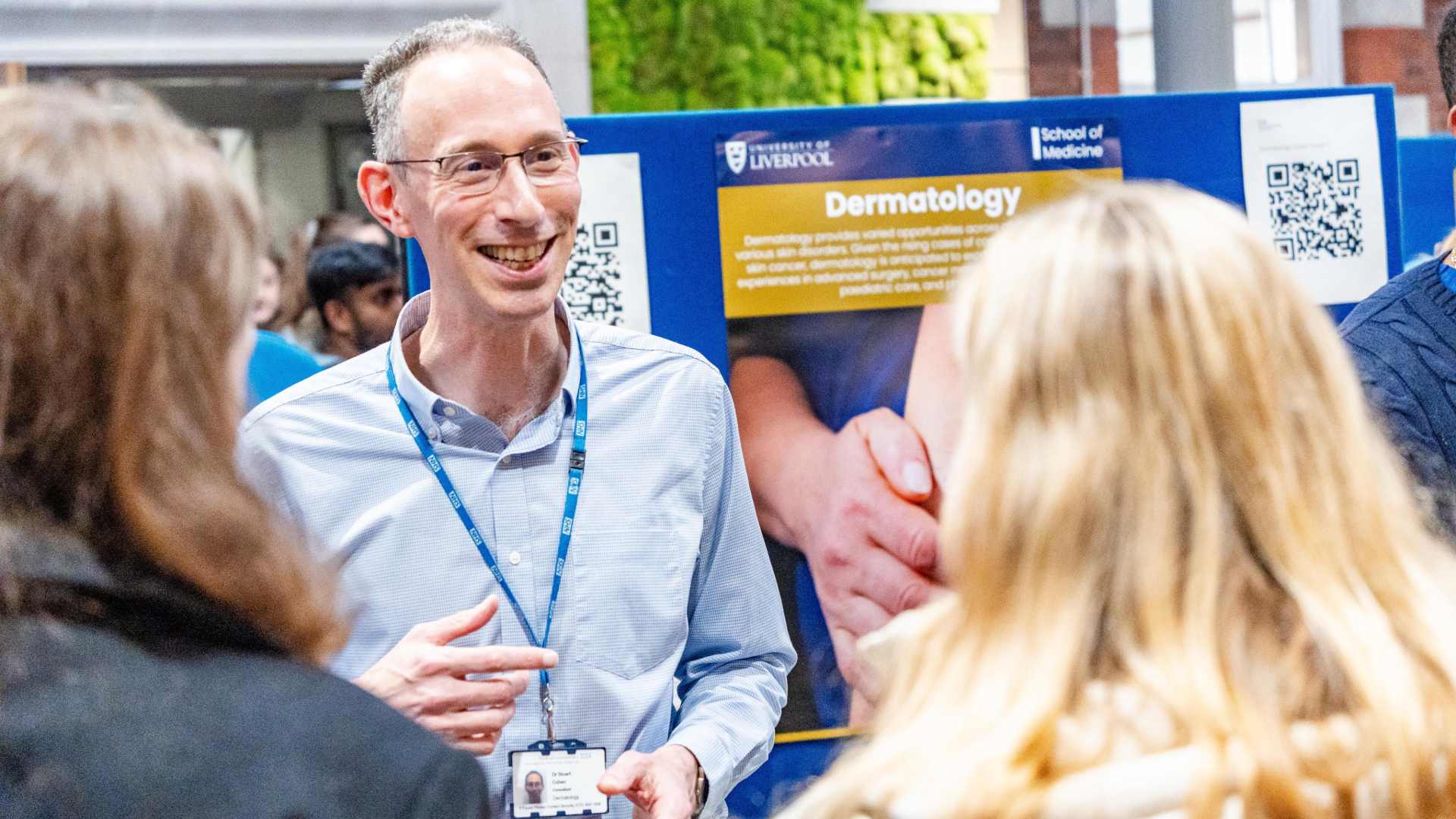 a clinician chats with students