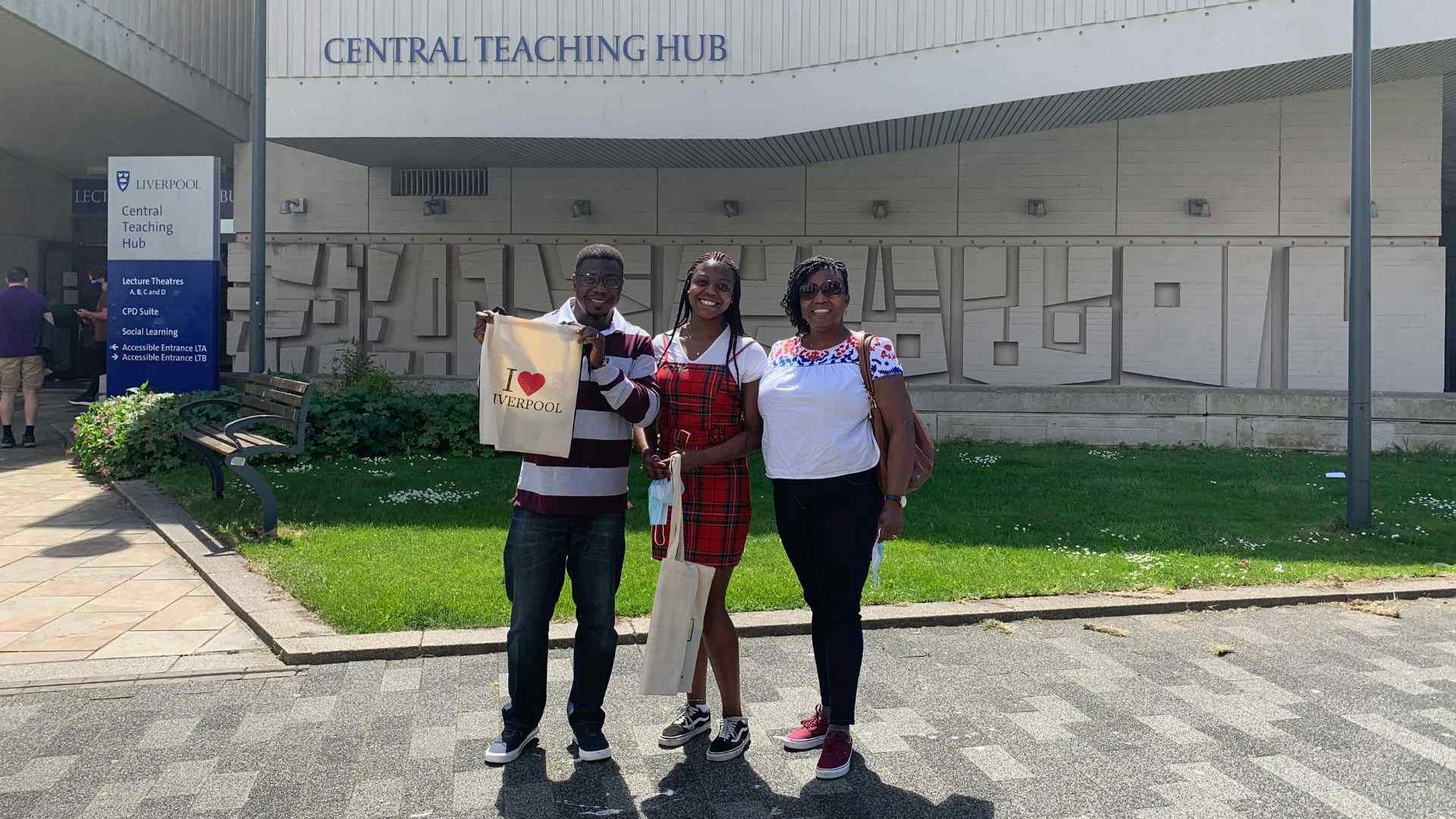 Emanuella Adu and her parents standing outside the Central Teaching HUB