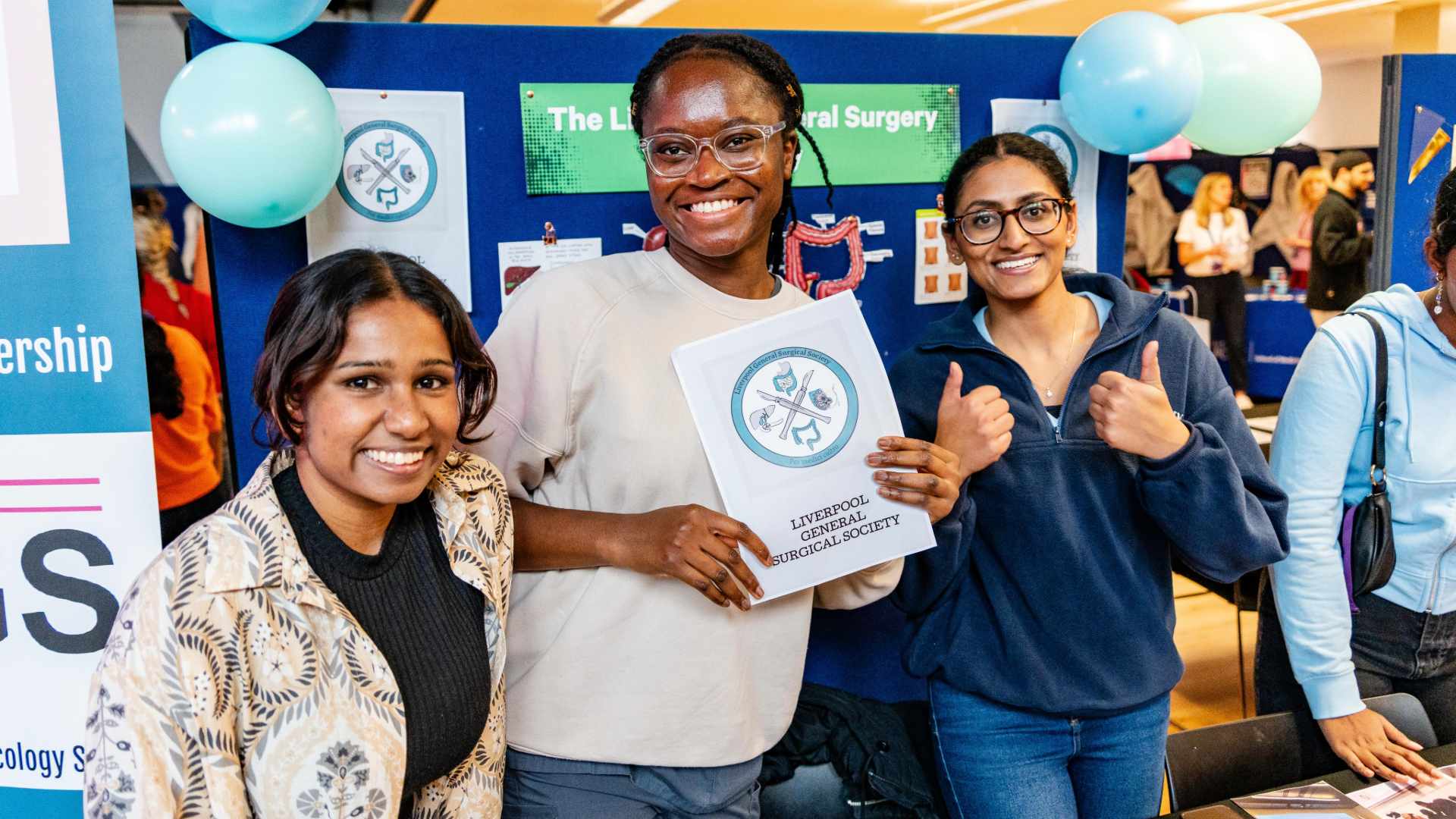 students pose with society logo