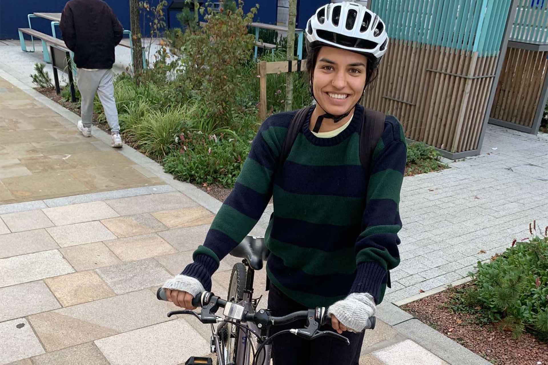 student on bike wearing helmet