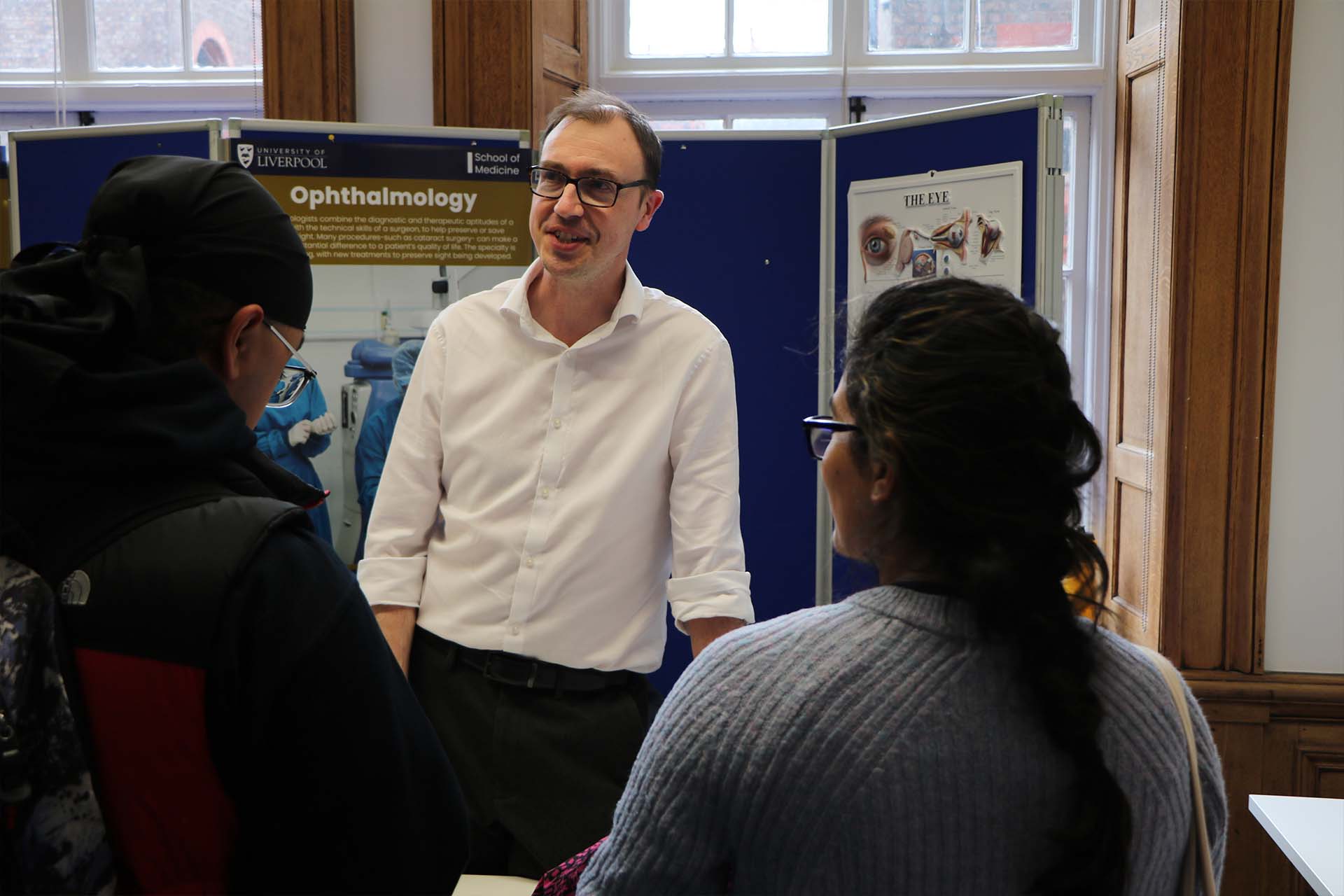 Clinician speaks with students at careers fair