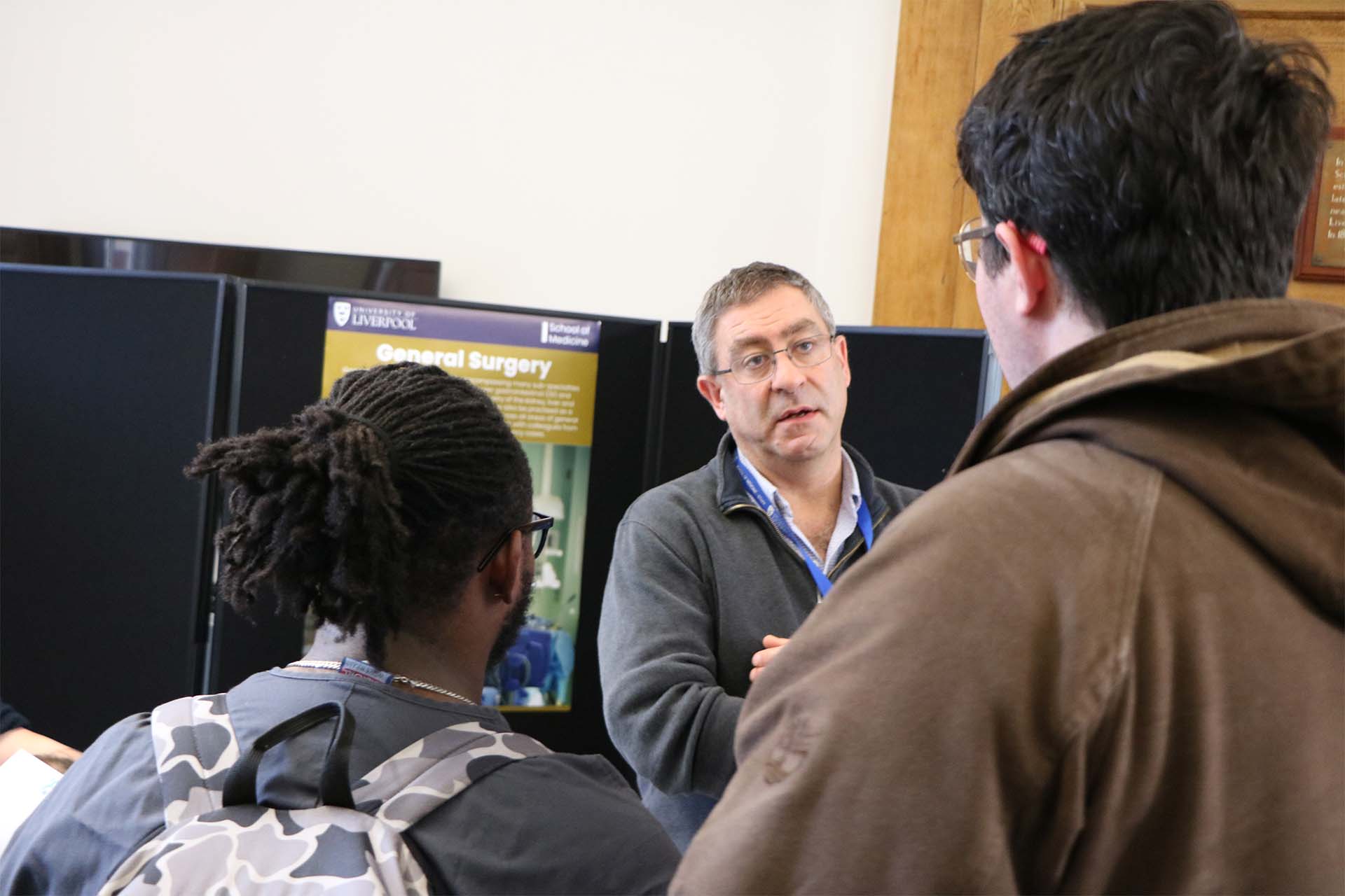 clinician talks with students at fair