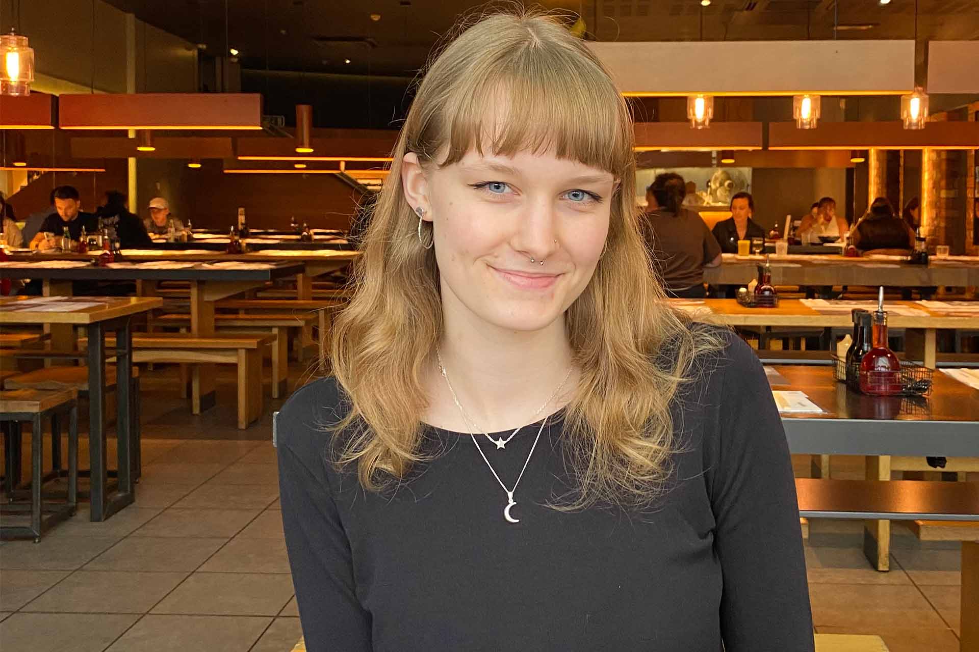 woman wearing black top in a restaurant