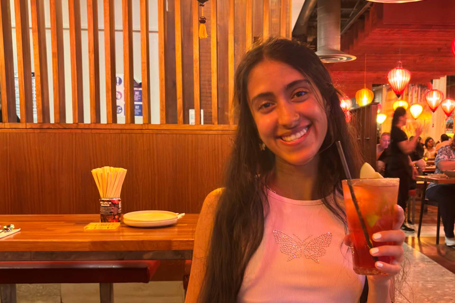 woman smiling to camera in a restaurant