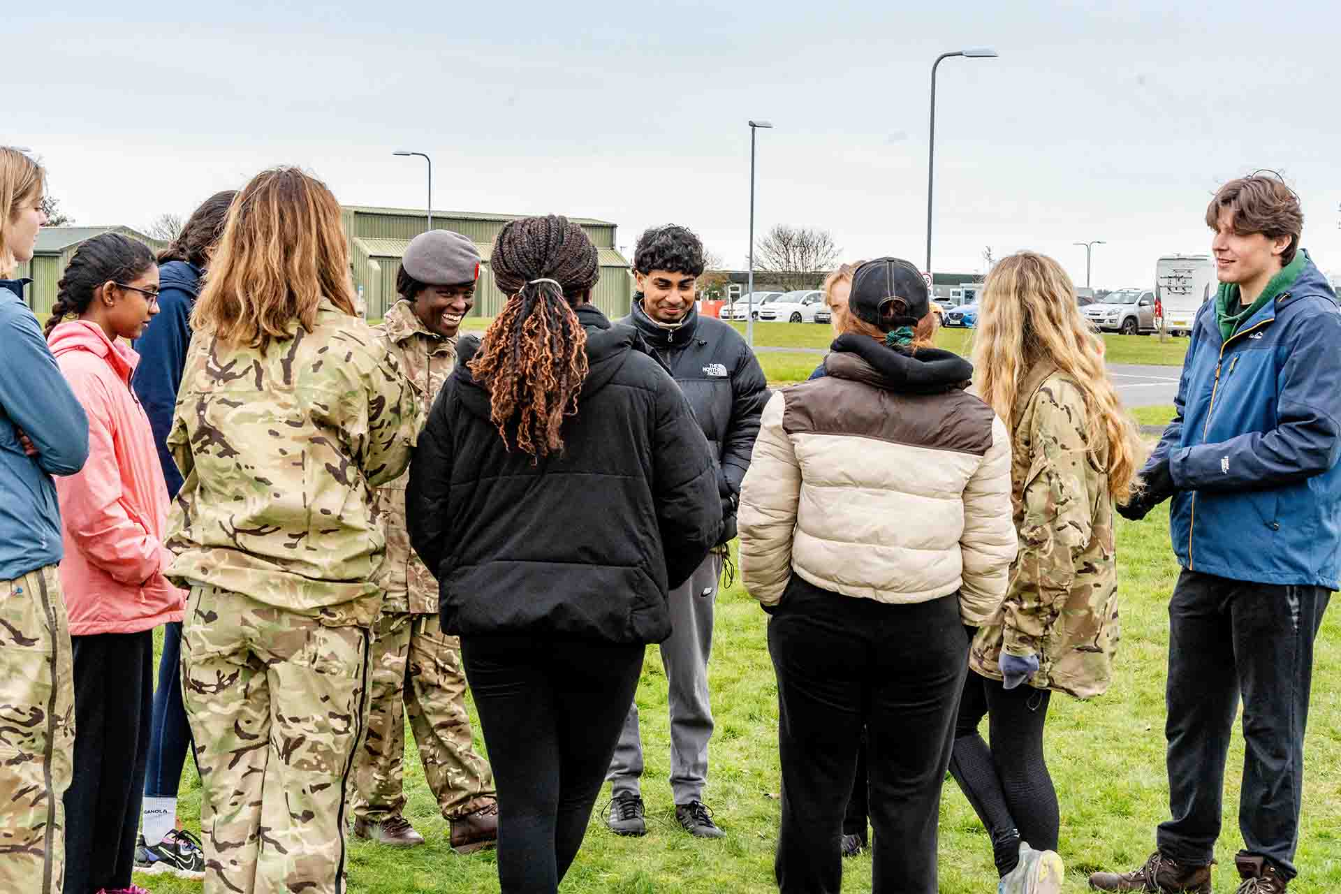 A group of students receiving feedback from an RAF instructor