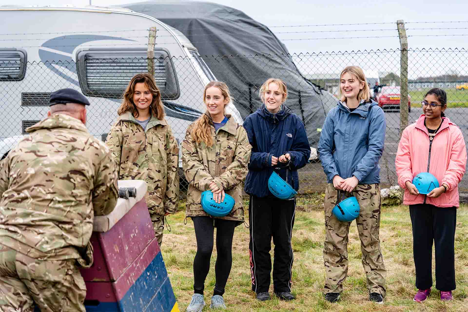 A group of female students stood laughing with an RAF instructor