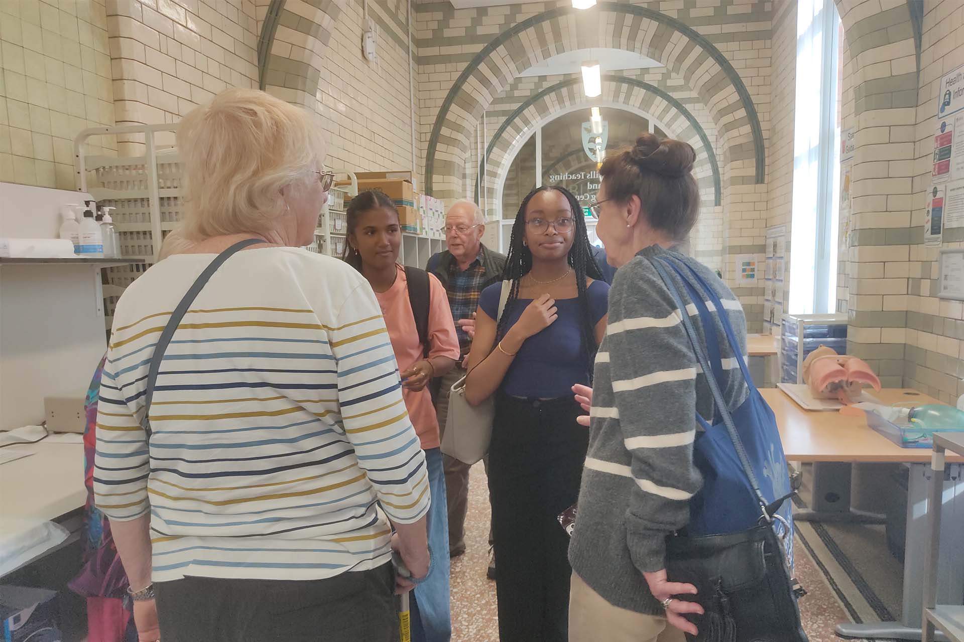 students speak with alumni in clinical training suite