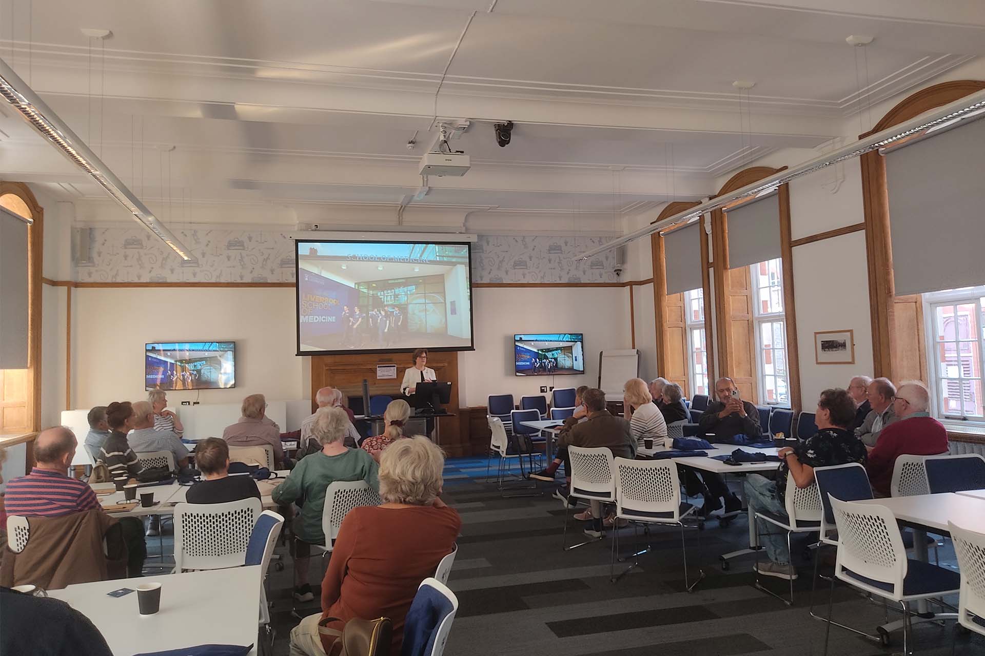 the Dean presents at alumni reunion