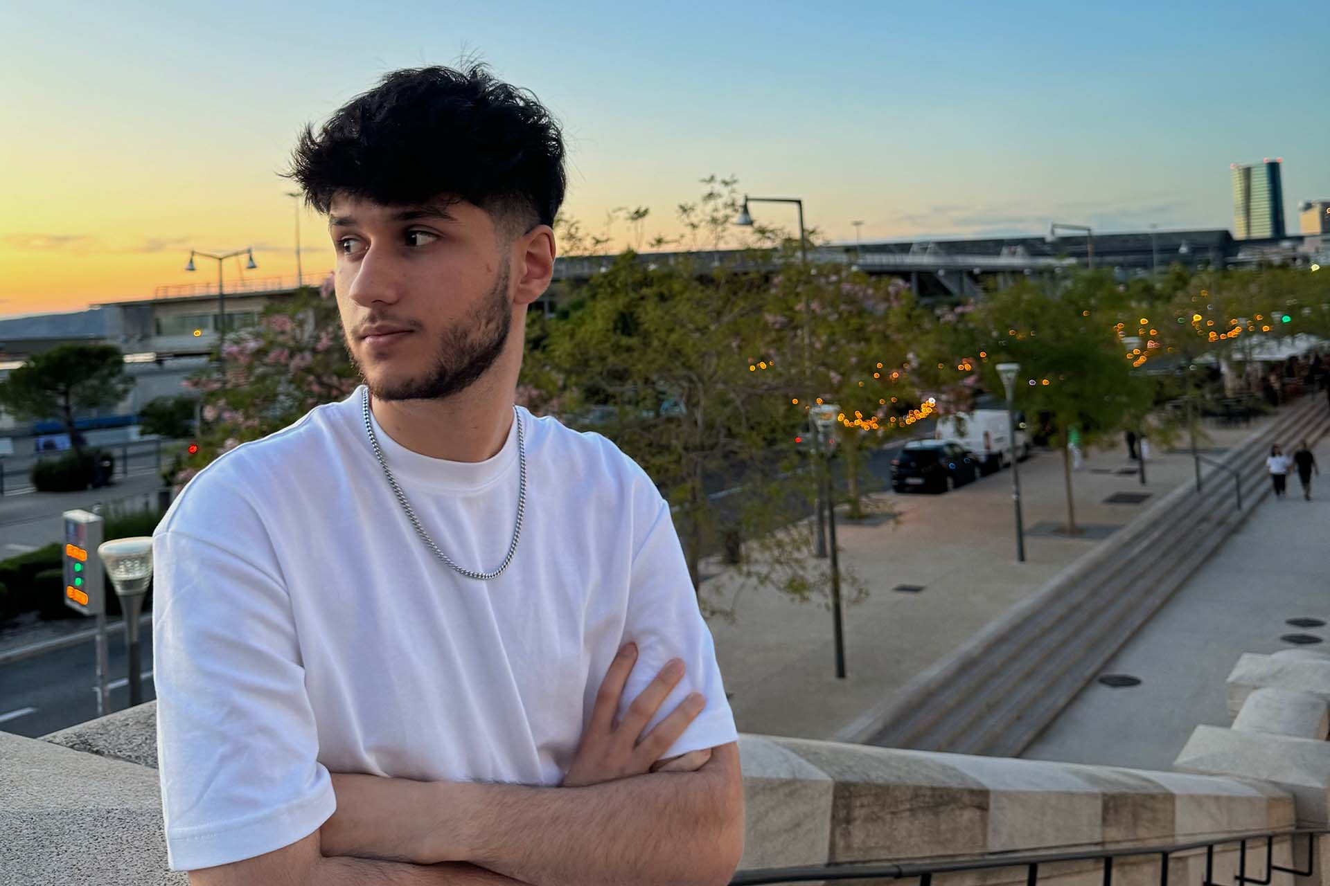 man with crossed arms at sunset