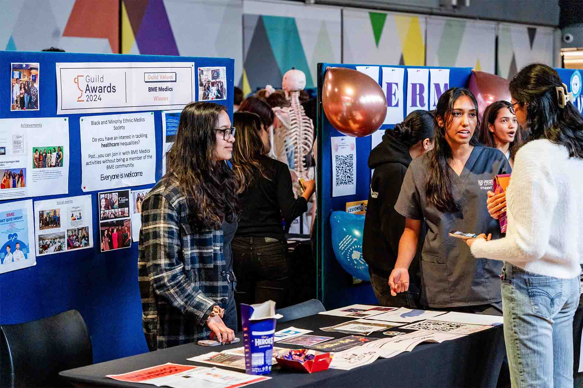 students interact at a fair showcasing different student societies