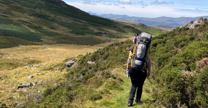 Student Erin on her Duke of Edinburgh hike in rolling hills