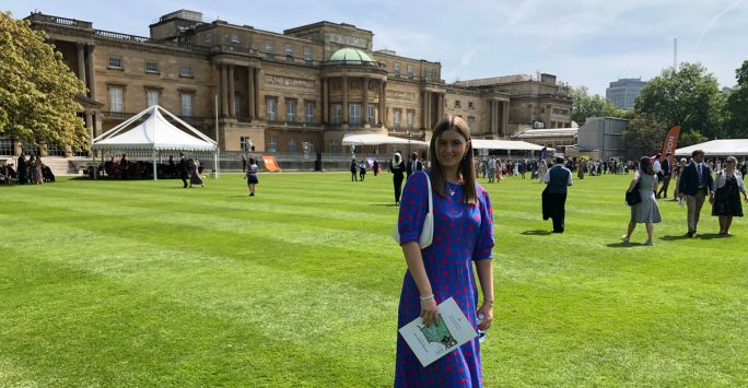 Student Erin poses in a sunny Buckingham Palace garden