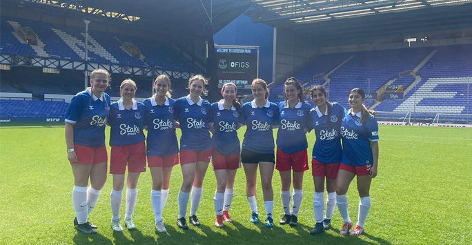 LMS women's team pose in Everton kits on the pitch at Goodison Park