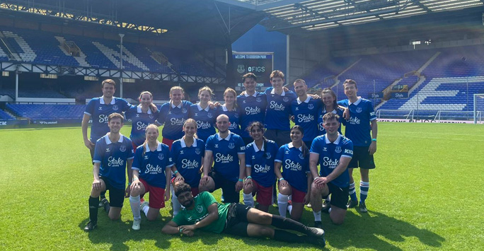 LMS men and women's teams pose on the pitch at Everton stadium