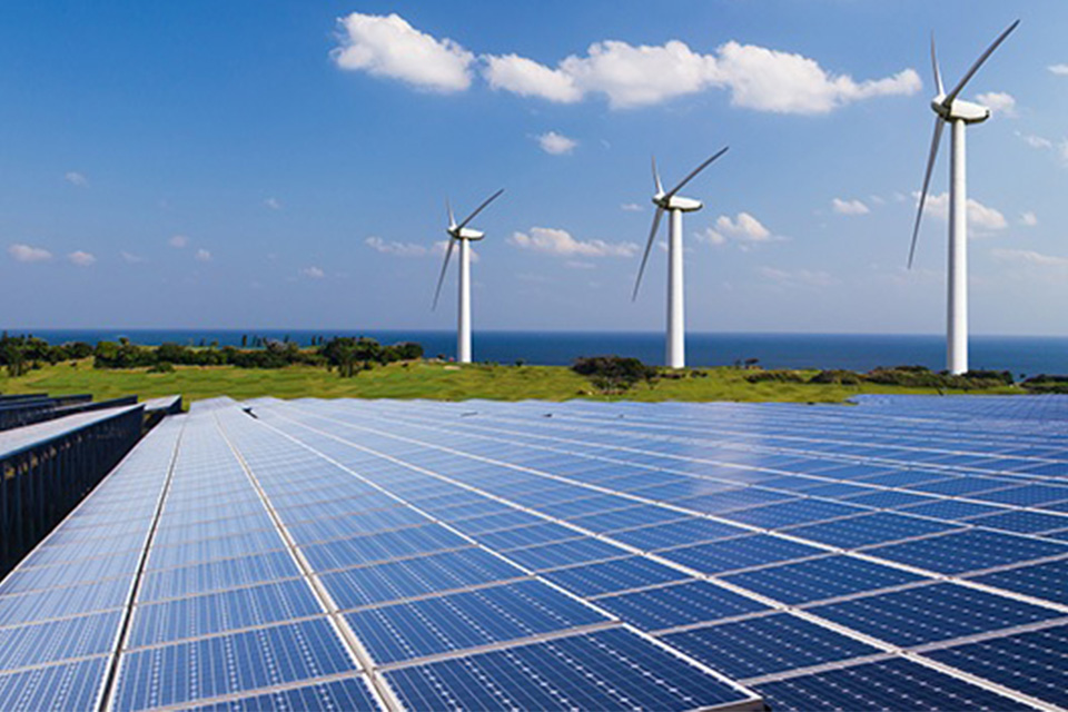 Solar panels and windfarms on a clear day