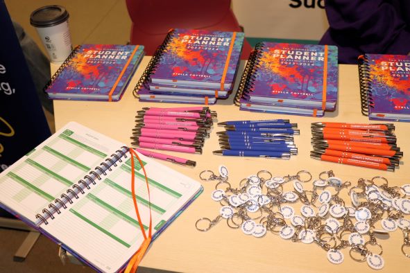 Diaries, pens and keyrings on top of a table